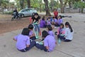 Asian teacher is teaching the music note for student group.